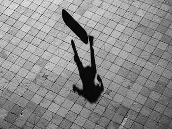 Shadow of man walking on street