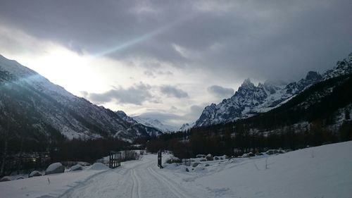 Scenic view of snow covered mountains against sky