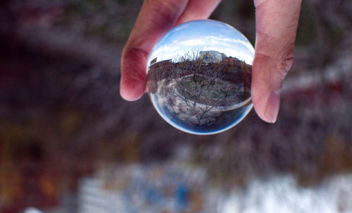 Close-up of hand holding crystal ball