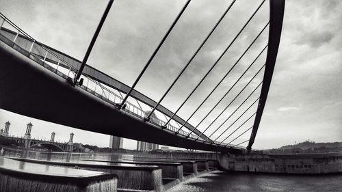 Low angle view of bridge over river against sky