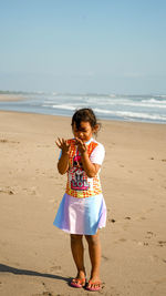 A little girl is playing on the beach