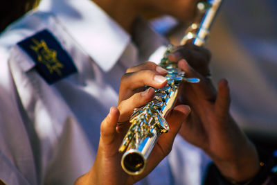 Midsection of man playing guitar