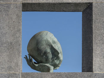 Low angle view of statue against clear blue sky