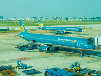 High angle view of airplane on airport runway against sky