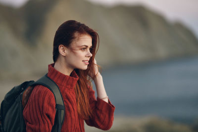 Young woman looking away outdoors