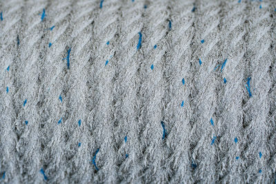 Close up of the fiber rope wound up tightly with speckled of blue threads