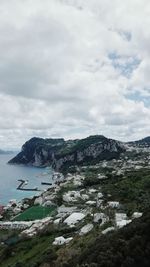 Scenic view of sea and mountains against sky