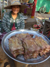 Portrait of woman holding food at market