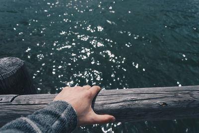 Low section of man on pier over lake