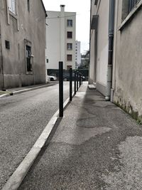 Empty alley amidst buildings in city