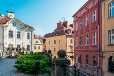 Statue amidst buildings in city against sky