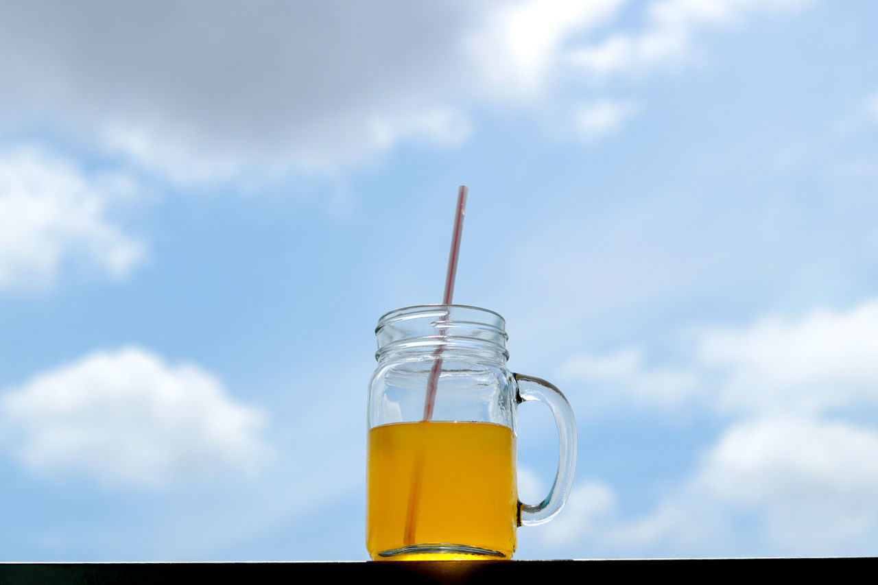 CLOSE-UP OF DRINK AGAINST GLASS