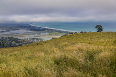 Panoramic view of ocean bay and sumner town in stormy day, christchurch suburbs, new zealand
