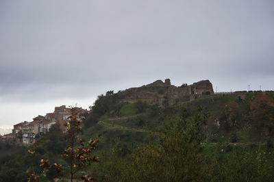 Castle on mountain against sky