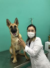 Portrait of veterinarian wearing mask with dog