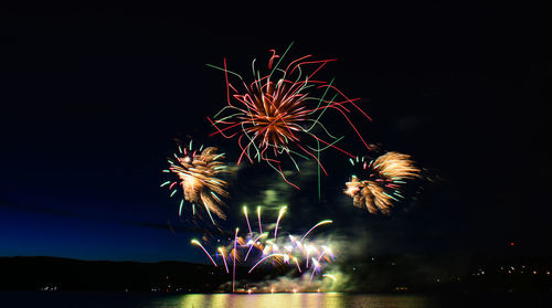 Low angle view of firework display at night