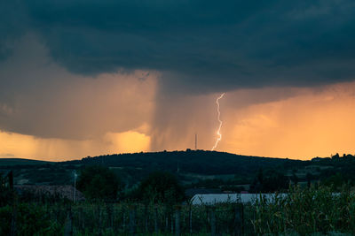 Lightning against orange sky