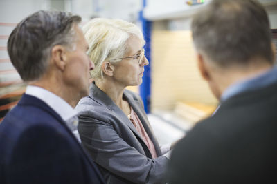 Businesswoman with colleagues in meeting at industry