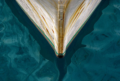 The bow of a boat in the water.