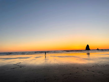 Scenic view of sea against clear sky during sunset