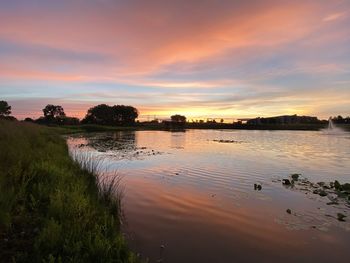 Scenic view of lake against orange sky