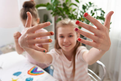 Sisters painting at home