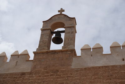 Low angle view of bell tower against sky