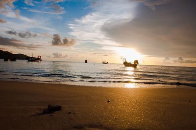 Scenic view of beach against sky during sunset