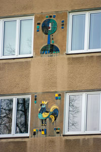 Low angle view of painting on glass window of building