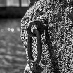 Close-up of rope tied up on metal chain