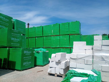 Stack of green box in row against sky
