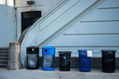 Row of garbage bin against building