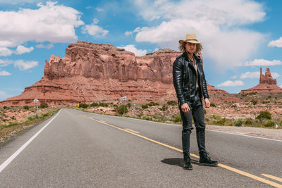 Man standing on road against sky