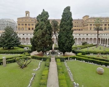 View of formal garden with buildings in background