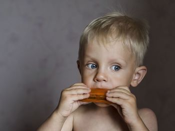 Close-up portrait of boy playing harmonica