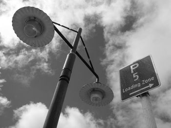 Low angle view of road sign against sky