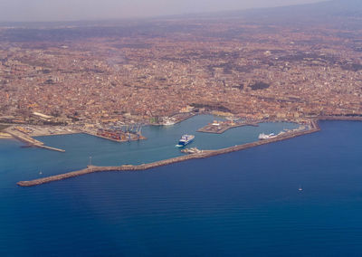 High angle view of sea and city