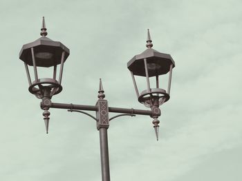 Low angle view of lamp post against sky
