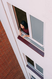 Portrait of woman with reflection on window