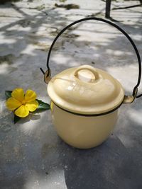 High angle view of yellow flower on table