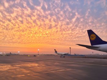 Airplane against sky during sunset