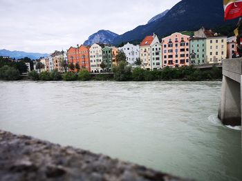 River by buildings against sky in city