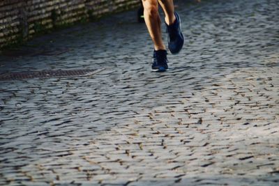 Low section of person walking on street