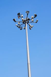 Low angle view of floodlight against clear blue sky