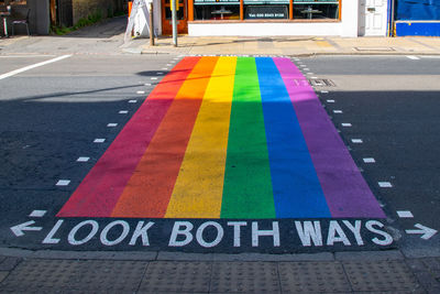 Close-up of rainbow painted on road in city