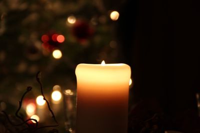 Close-up of illuminated candles against blurred background