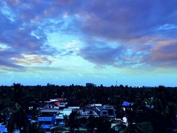 High angle view of cityscape against cloudy sky