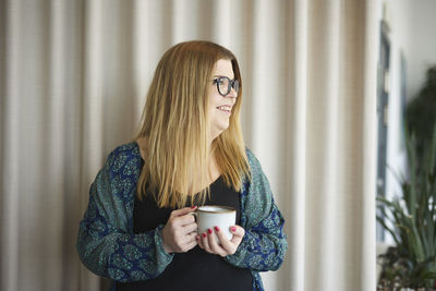 Smiling woman holding coffee cup