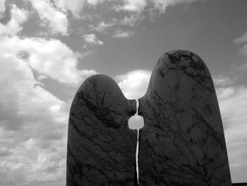 Low angle view of heart shape against sky