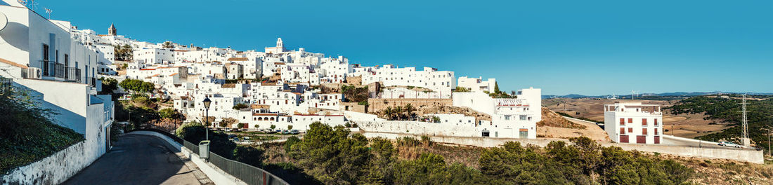 High angle view of houses in town against clear sky